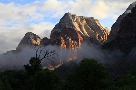 Photo of Zion National Park in early morning light with low hanging clouds